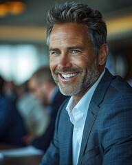 Fototapeta premium A businessman with graying hair smiles confidently while attending a business meeting