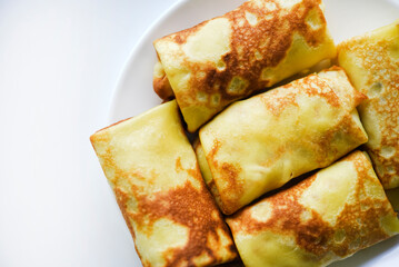Pancakes with meat on a plate. Delicious envelopes with meat.