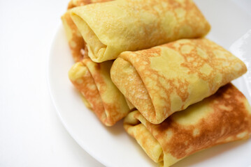 Pancakes with meat on a plate. Delicious envelopes with meat.