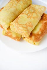 Pancakes with meat on a plate. Delicious envelopes with meat.