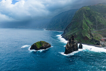 Madeira seacoast with huge rock Ribeira da Janela in water Atlantic ocean, Portugal. Aerial view