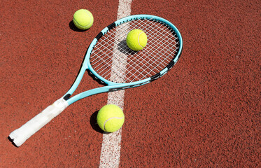 Tennis scene with balls, racquets and hard court surface corner lines