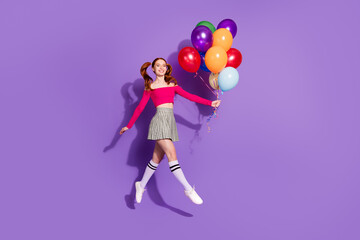 Full length photo of shiny attractive lady dressed off shoulders top jumping rising balloons bouquet empty space isolated violet color background