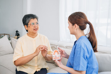 A woman in glasses is talking to a Female Dentist in a blue uniform
