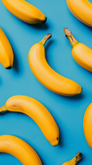 Seamless pattern of yellow bananas arranged in a random fashion on a light blue background. Mobile screensaver concept. 