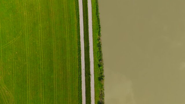 River Inn aerial view of agricultural fields and nature near town of Muhldorf am Inn in sunny summer weather. Bavaria, Germany River Inn drone view of meadows and countryside. Aerial of farmland. 
