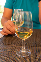 Tasting of Bordeaux white wine in Sauternes, left bank of Gironde Estuary, France. Glasses of white sweet French wine served in restaurant