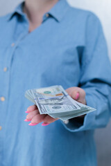 female hands holding American dollar paper bills