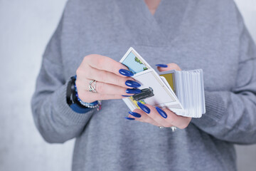 Female hands holding tarot cards for fortune telling and tricks