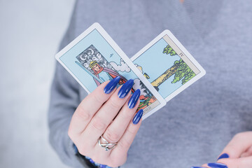 Female hands holding tarot cards for fortune telling and tricks