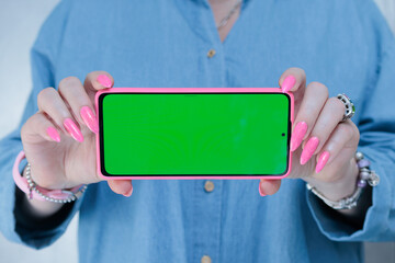 Woman's hands holding a large smartphone