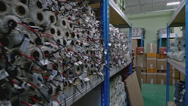 A large warehouse of products in rolls. Creative. Moving along shelves in storage house.