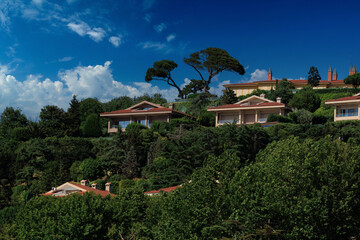 Southern cityscape, view of buildings and houses with green plants in public places in Turkey, sunny summer day in the city of Istanbul