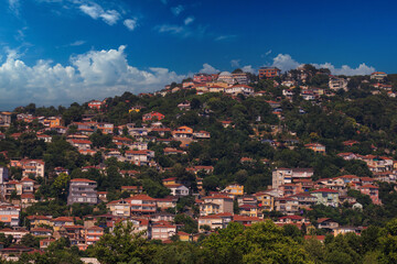 Fototapeta premium Southern cityscape, view of buildings and houses with green plants in public places in Turkey, sunny summer day in the city of Istanbul