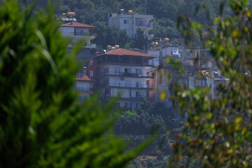 Southern cityscape, view of buildings and houses with green plants in public places in Turkey, sunny summer day in the city of Istanbul