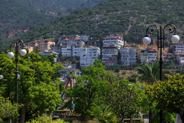 Obraz premium Southern cityscape, view of buildings and houses with green plants in public places in Turkey, sunny summer day in the city of Istanbul