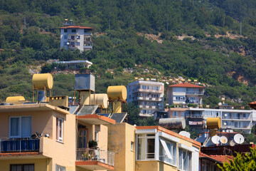 Fototapeta premium Southern cityscape, view of buildings and houses with green plants in public places in Turkey, sunny summer day in the city of Istanbul