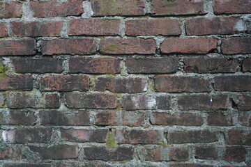 Abandoned mossy brick layered wall background, Grungy brick wall texture background, Weathered rusty brick backdrop