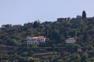 Southern cityscape, view of buildings and houses with green plants in public places in Turkey,...