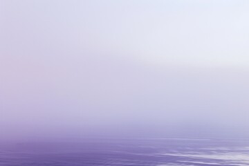 Fototapeta premium Disturbed water ripples, fog envelops the horizon in purple hues. Serene scene with misty atmosphere, dreamlike reflections perfect for backgrounds
