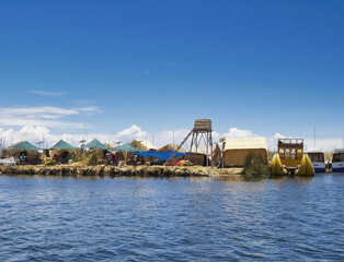 The floating villages of Puno (Peru) on Lake Titicaca are artificial islands built with totora, a...