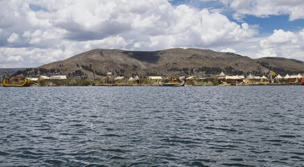 The floating villages of Puno (Peru) on Lake Titicaca are artificial islands built with totora, a...