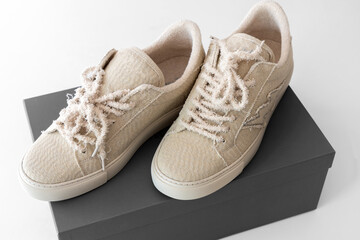 A pair of new beige sneakers in a box. High quality photo