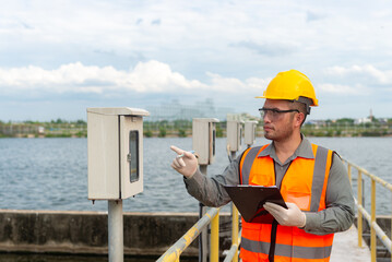 an engineer point his finger at the valve gauge plumbing system and try to check pressure value to...