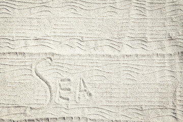 Obraz premium A drawing on the sand by the sea travel background