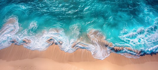Fototapeta premium Aerial top view of a white sand beach and turquoise sea water with waves in the morning