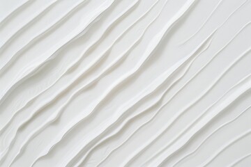 Obraz premium White cosmetic cream texture is forming wavy lines on a white background, creating an abstract and elegant pattern. This background is perfect for beauty, skincare, and wellness projects
