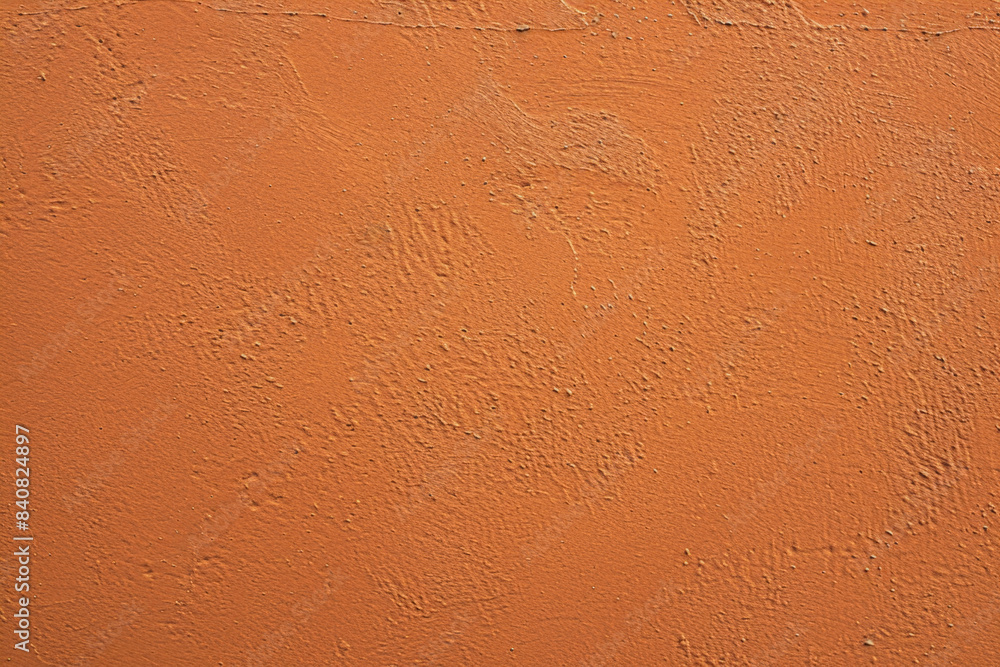 Poster rough orange wall texture background with a subtle grunge effect, providing a vibrant and textured b