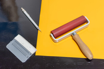 Work tools for the production and installation of advertising stickers from self-adhesive foil.