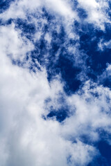 Beautiful blue sky with many clouds. Space for advertising. Vertical.