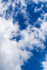 Beautiful blue sky with many clouds. Space for advertising. Vertical.
