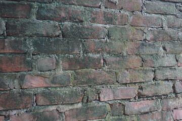 Abandoned mossy brick layered wall background, Grungy brick wall texture background, Weathered rusty brick backdrop