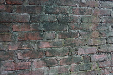 Abandoned mossy brick layered wall background, Grungy brick wall texture background, Weathered rusty brick backdrop