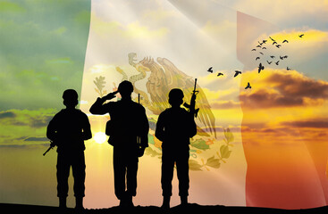 Silhouettes of soldiers with a background of the Mexico flag and a sunset or sunrise. Concept of...