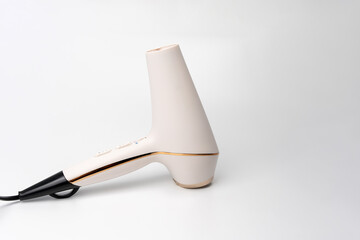 Hair dryer for drying hair on a white background. The buttons are labeled 