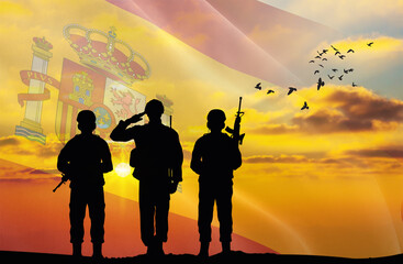 Silhouettes of soldiers with a background of the Spain flag and a sunset or sunrise. Concept of...
