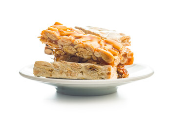 Close Up of almond Brittle Bars With Caramelized Coating and coffee cup isolated on white background.