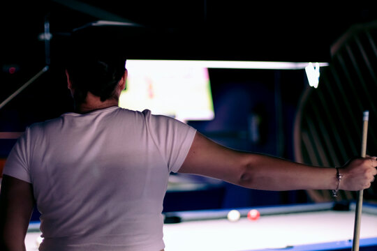 Juego de Billar: Mujer de espaldas sosteniendo palo de billar