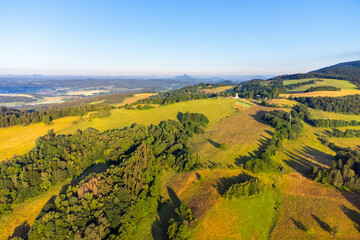 Fototapeta premium Green hilly landscape with green meadows and forests. Jested ridge near Liberec, Czechia. Aerial view from drone.