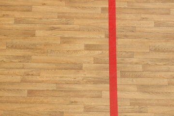 Wooden floor basketball, badminton, futsal, handball, volleyball, football, soccer court. Wooden floor of sports hall with red marking lines on wooden floor indoor, gym court