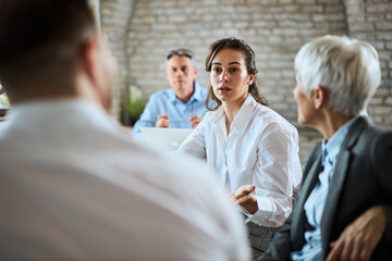 Young entrepreneur discussing with his colleague on a business meeting in the office