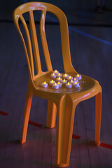 plastic chair painted yellow with candles placed on the seat, the symbol of the release of Israeli...