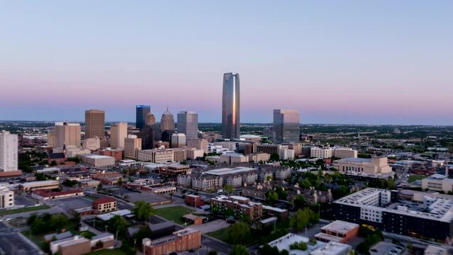 Aerial view of Oklahoma City's skyline at dusk, highlighting its iconic skyscrapers and urban layout as the evening light fades
