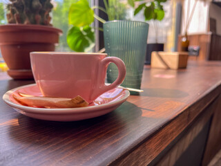 Cappuccino coffee cup at cafe on wooden windowsill