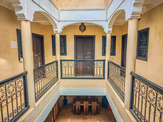 Interior of a typical Moroccan riad with a small pool in the middle of the building. Accommodation in traditional Moroccan hotel in Medina