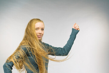 Smiling woman with blowing long hair